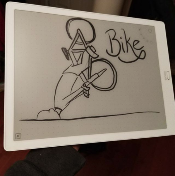 A photo of my e-ink tablet, on the screen is a cartoon of me crashing the bike