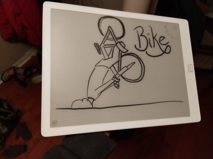 a photo of an e-ink tablet with a drawing of me crashing my bike